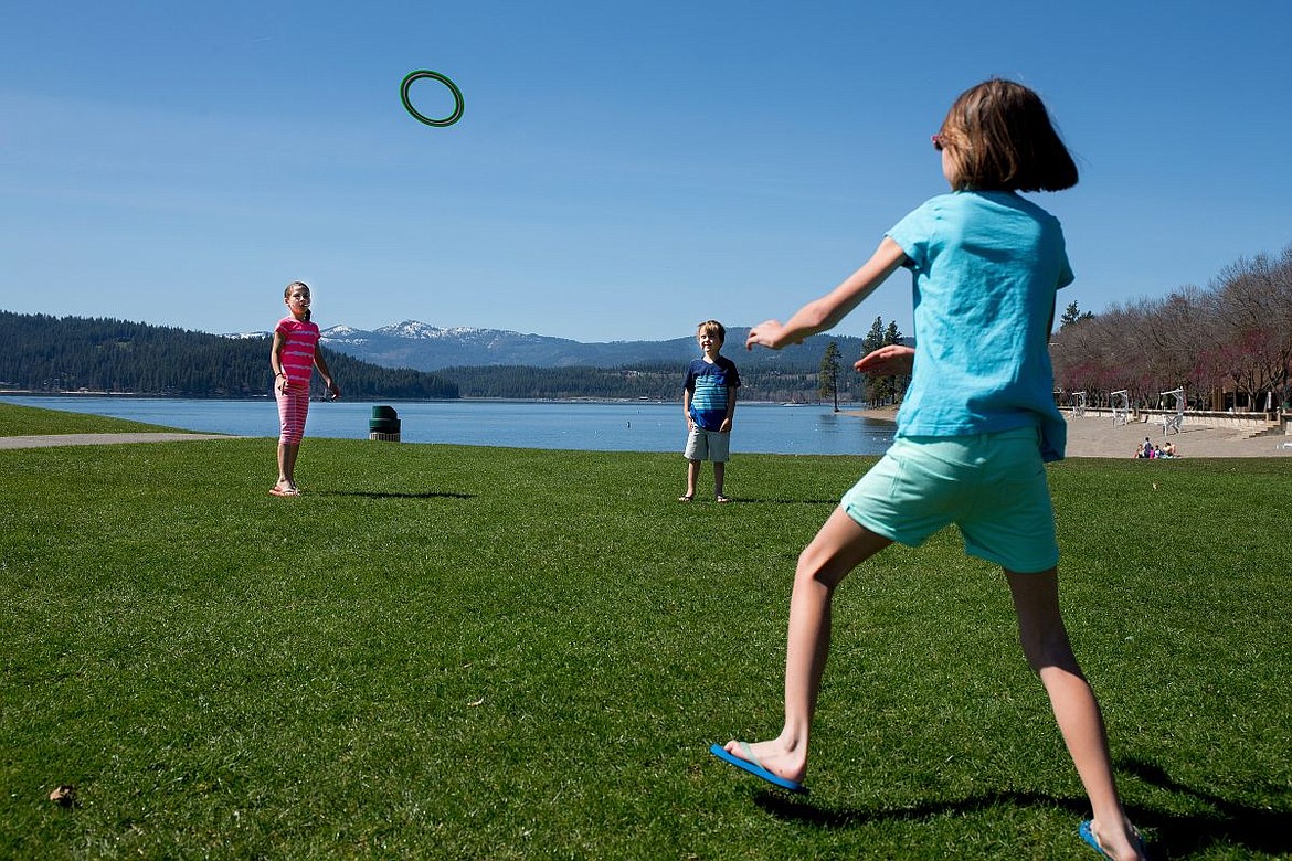 &lt;p&gt;From left to right, Dakota, Nolan and Callie Hansen toss a flying disc to each other on Thursday at Independence Point in Coeur d'Alene.&lt;/p&gt;