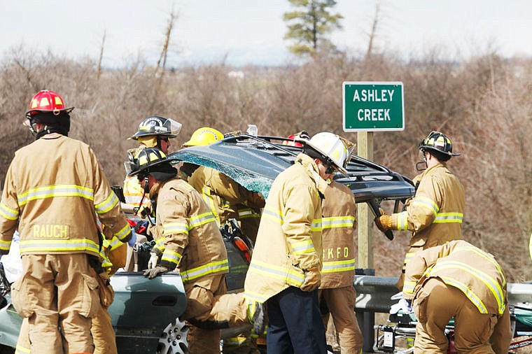 &lt;p&gt;&lt;strong&gt;Firefighters lift&#160;&lt;/strong&gt;the roof off a Subaru Outback station wagon so the injured driver can be removed. The Subaru collided head-on with a full-size Chevrolet Silverado pickup truck near the Ashley Creek bridge on U.S. 93 Alternate Route&lt;/p&gt;
&lt;p&gt;&#160;&lt;/p&gt;