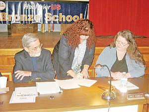 &lt;p&gt;Flanked by Superintendent K.W. Maki and Board President Tracy Comeau, new Libby High School Principal Ruth Ann VanWorth-Rogers signs her one-year contract.&lt;/p&gt;