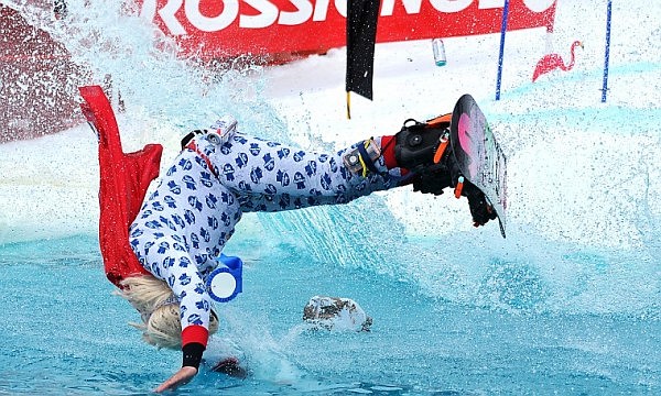 Brett Urbach flips through the air before going into a man-made pond on Saturday afternoon during the sixth annual Pond Skim at Whitefish Mountain Resort at Big Mountain. The vent marks the end of the ski season on the hill.