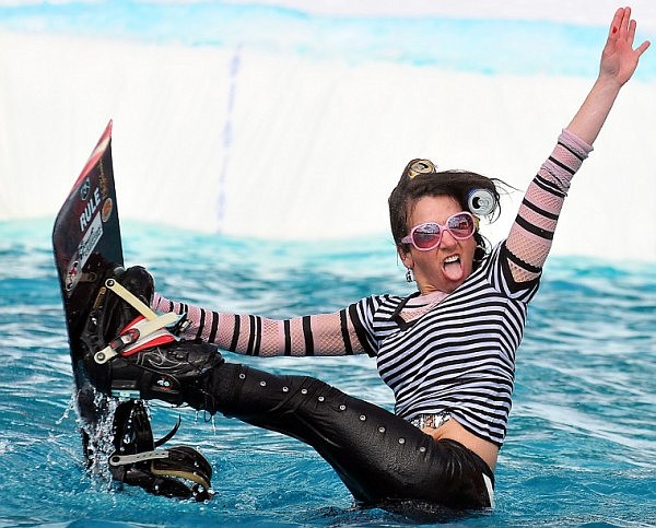 A participant strikes a pose after falling into the pond.