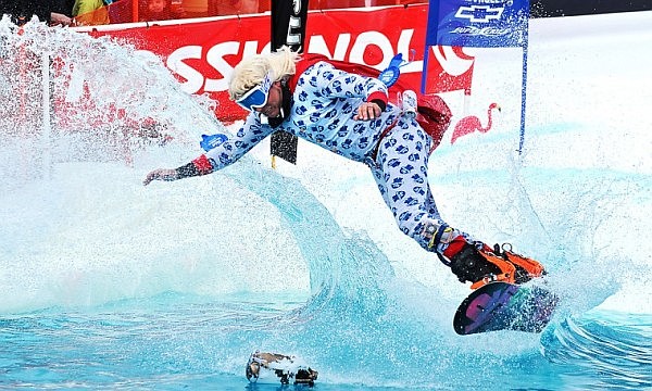 Brett Urbach flips through the air before going into a man-made pond on Saturday afternoon during the sixth annual Pond Skim at Whitefish Mountain Resort at Big Mountain. The vent marks the end of the ski season on the hill.