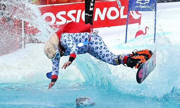 Brett Urbach flips through the air before going into a man-made pond on Saturday afternoon during the sixth annual Pond Skim at Whitefish Mountain Resort at Big Mountain. The vent marks the end of the ski season on the hill.