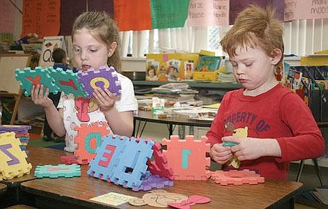 Photo by Nick Ianniello Pre-kindergartners Joshua Maier and Genisis Rebiah play together at the Superior Elementary School Kindergarten Round-up Wednesday. Kids at the round up got to check out their new school and take a test to find out how prepared for school they are.