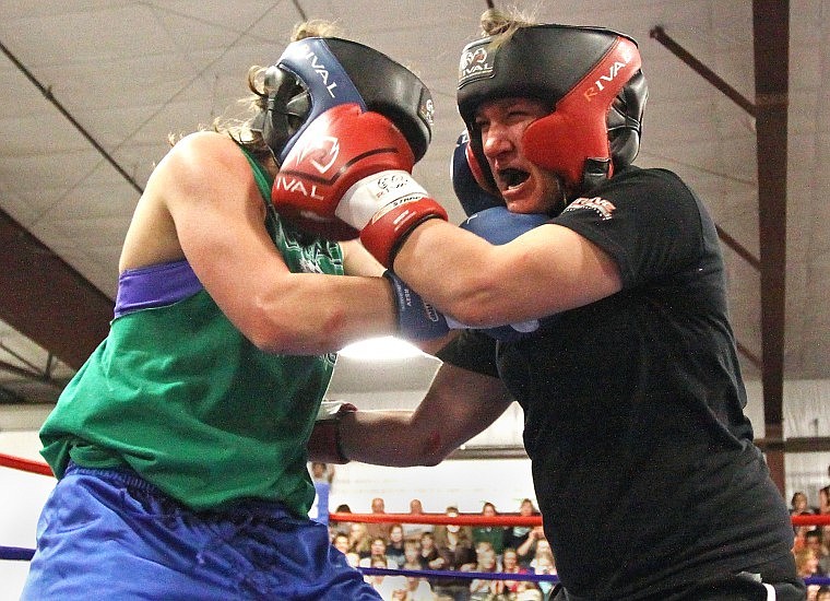 A bloody Cera Lau of Flathead punches Glacier's Nicole Heavirland during their bout on Thursday.