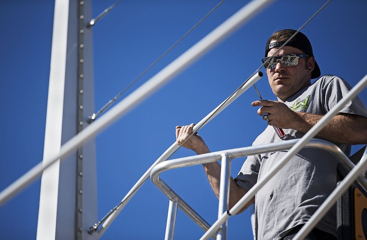 &lt;p&gt;Randy Pettyjohn, pro installer for CW Wraps and Marketing, uses a screwdriver to slide a lightweight PVC pipe onto the cables of the &quot;Under the Rainbow&quot; sculpture at the entrance of McEuen Park at Fourth Street in downtown Coeur d'Alene on Friday.&lt;/p&gt;