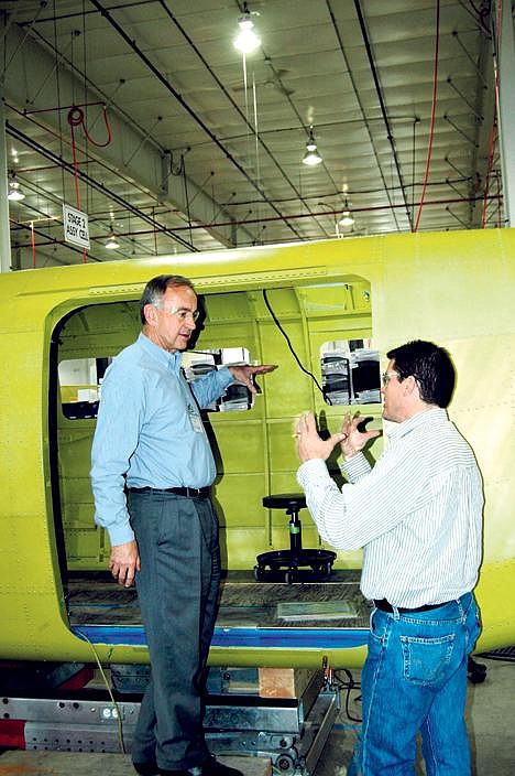 Rep. Walt Minnick, D-Idaho, listens to Quest Aircraft CEO Paul Schaller explain the process of building a Kodiak airplane. (Photo by CONOR CHRISTOFFERSON)