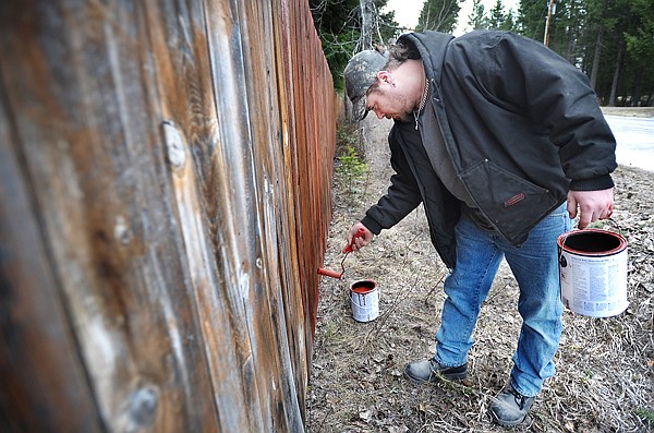 Brenda Ahearn/Daily Inter Lake
Donald Hancock of Kalispell stains a fence for a friend of his on Monday near Lake Blaine.