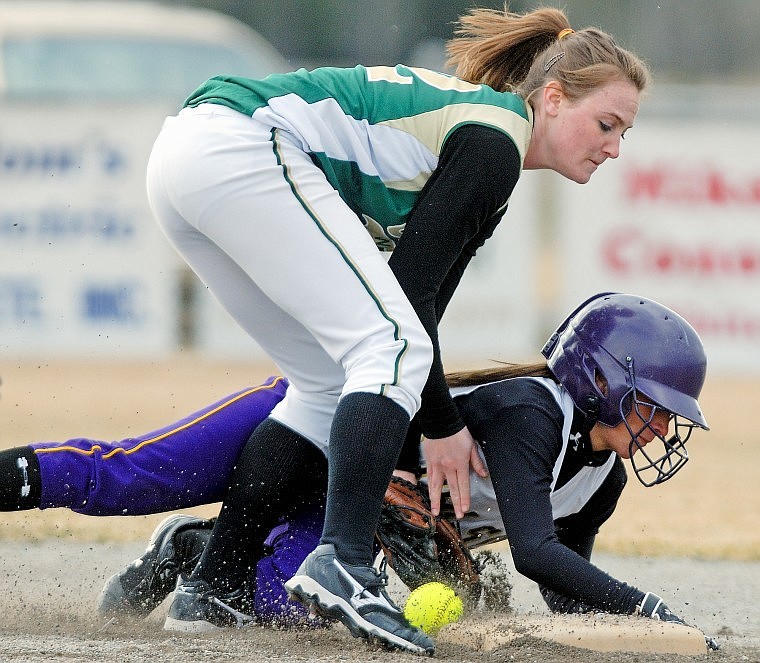 Whitefish's Madison Tveidt tries to recover the ball as Polson's Kodi WIlson slides into second base. Wilson was safe on the play.