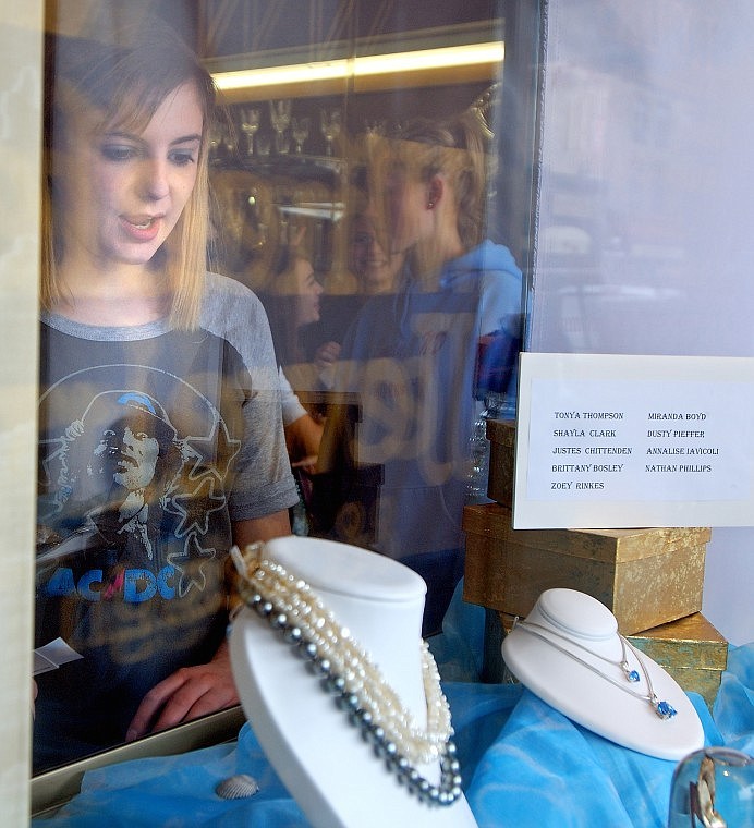 Glacier High School freshman Brittany Bosley takes a look Friday afternoon at her team&#146;s window display at Wheeler Jewelry in downtown Kalispell. Students in Lori Gray&#146;s applied careers class put together the displays, starting with eight displays with the final four being voted on by the public on Wheeler Jewelry&#146;s Facebook page and www.jewelrymontana.com.