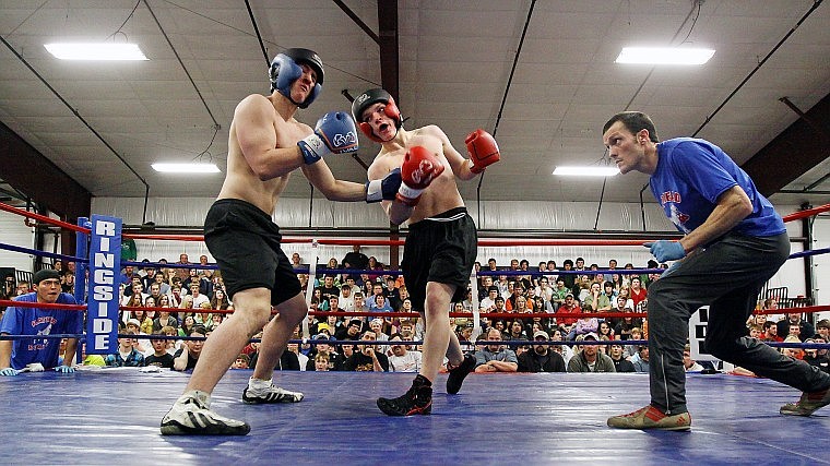 Flathead&#146;s Larry Francis fires a shot at Glacier&#146;s Logan Clay while referee Phillip Moore looks on during the first annual crosstown boxing smoker Thursday evening at Gardner Auction.