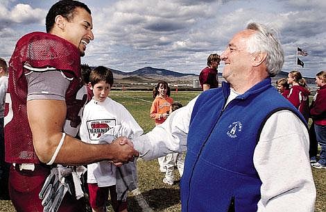 Karen Nichols/Daily Inter Lake &lt;br&gt;Former Flathead Braves football coach Gene Boyle, right, congratulates former Flathead star Lex Hilliard after the scrimmage. Boyle was the running backs coach for the Braves during Hilliard's high school career.