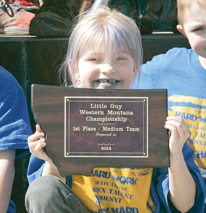 &lt;p&gt;Brooke Yeadon proudly displays the Little Guy Western Montana Championship First Place plaque Thursday afternoon at Libby High School.&lt;/p&gt;