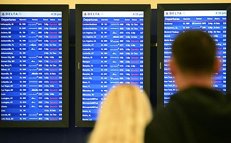 &lt;p&gt;Airline passengers look at departure screens with flight cancellations posted as a winter storm bringing a mix of snow, sleet and rain resulted in an FAA-ordered ground stop at Hartsfield-Jackson International Airport in Atlanta, Feb. 25.&lt;/p&gt;