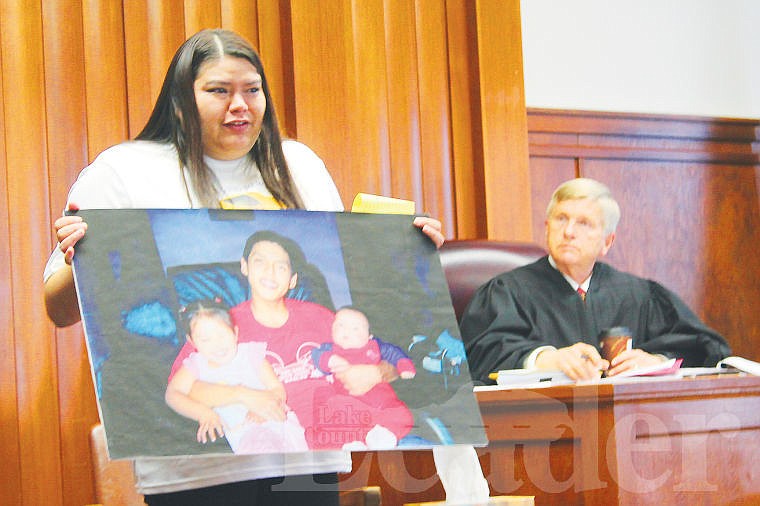 &lt;p&gt;Kayla Ridgely holds up an enlarged photo of her cousin, Laurence Kenmille, during her victim statement in court.&lt;/p&gt;