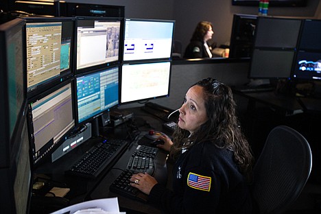 &lt;p&gt;Emergency call operator for the Post Falls police department works at her station Wednesday. Post Falls police will be sending out live feeds over Facebook and Twitter Friday night during what they are calling a &#147;Tweet Along&#148; in order to give the public a glimpse into the typical night of an officer.&lt;/p&gt;