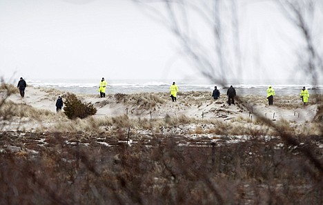 &lt;p&gt;Emergency personnel search the dunes and scrub near the ocean, across the road from where eight bodies were found on April 5, near Oak Beach, N.Y.&lt;/p&gt;