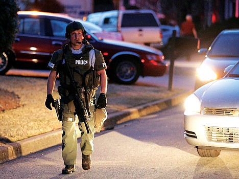 &lt;p&gt;A police officer leaves the scene after an explosion and gunshots were heard near the scene where a man was holding four firefighters hostage Wednesday in Suwanee, Ga.&lt;/p&gt;