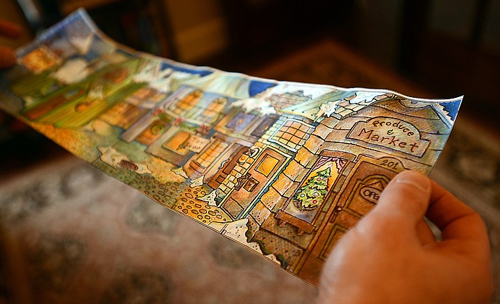 <p>Shane Morgan displays a sketch he did of a set for a Christmas production at the Christian Center. That event helped open the door for Morgan’s work as an illustrator.</p>