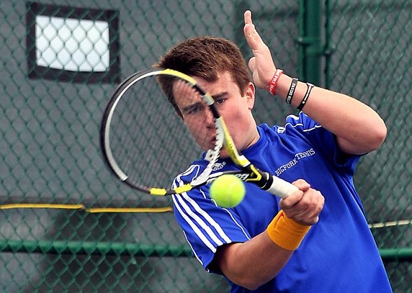 Bigfork's Colter Mahlum keeps his eye on the ball as he connects with it during a match against Glacier High at Flathead Valley Community College on Monday afternoon.