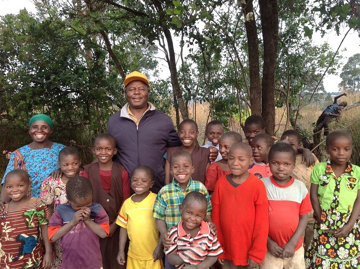 &lt;p&gt;Father Bruno D. Mgaya, center, stands with a matron, left, and orphaned children of the Mafinga Upendo Community in Tanzania in 2015.&lt;/p&gt;