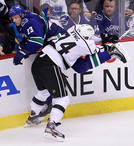 &lt;p&gt;Los Angeles Kings left wing Dwight King (74) checks Vancouver Canucks defenseman Alexander Edler (23) during the second period of Game 1 of an NHL hockey first-round playoff series Wednesday, April 11, 2012, in Vancouver, British Columbia. (AP Photo/The Canadian Press, Jonathan Hayward)&lt;/p&gt;