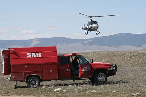 A medevac helicopter from Missoula lands in a field near the scene of a fatal car accident on Saturday. Only one man survived as his two passengers appear to have drowned in the Flathead River.