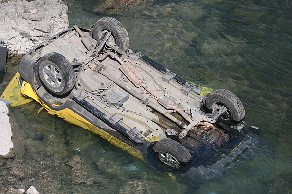 The yellow, 2002 SUV involved in the fatal accident sits overturned in the cold waters of the Flathead River. Two Missoula men were killed in the wreck while one man survived and was medevaced to a Kalispell hospital.