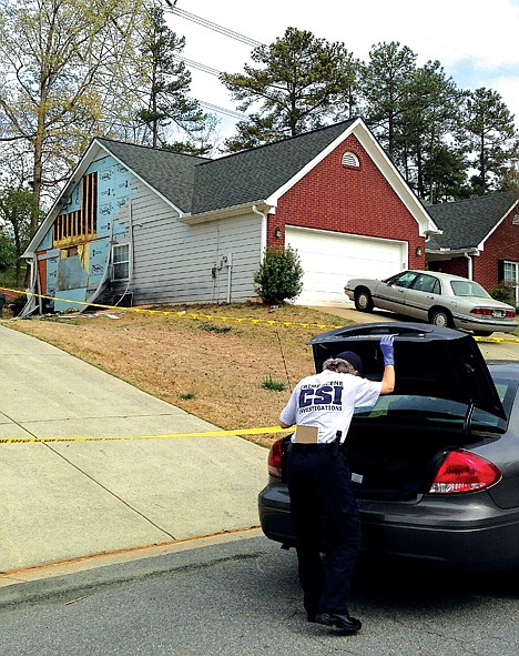 &lt;p&gt;An investigator arrives at a damaged home in Suwanee, Ga. on Thursday, after Wednesday's hostage standoff. A man held four Gwinnett County firefighters hostage for hours before they where freed when police officers stormed the house Wednesday.&lt;/p&gt;