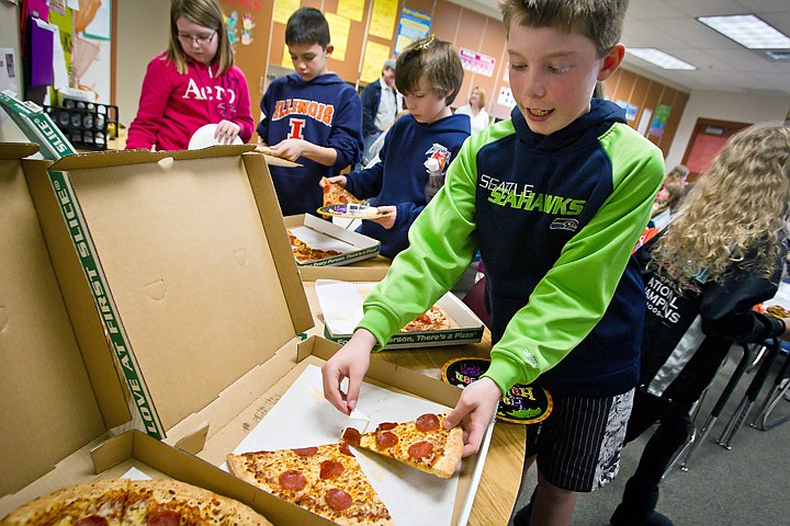 &lt;p&gt;JEROME A. POLLOS/Press Nick Goldthorpe grabs a slice of pizza his fifth-grade class of 33 students at Atlas Elementary received Friday for their artistic efforts in designing a poster for the &quot;Name-the-Hayden-Days-Theme&quot; contest.&lt;/p&gt;
