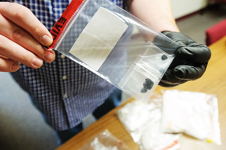 &lt;p&gt;FLATHEAD COUNTY EVIDENCE TECHNICIAN Jared Lako displays an evidence bag containing about two grams &#151; or 20 &#147;points&#148; &#151; of heroin at the Flathead County Sheriff&#146;s Office in Kalispell Friday. Local law enforcement agencies are reporting an increase in the activity of the drug on their streets. (Patrick Cote/Daily Inter Lake)&lt;/p&gt;