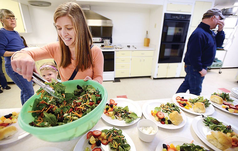 <p>Kristi Sanders of Kalispell helps prepare plates on Thursday, April 10 at the Feeding the Flathead dinner at the Central Christian Church in Kalispell. Sanders has been a volunteer for two years. (Brenda Ahearn/Daily Inter Lake)</p>