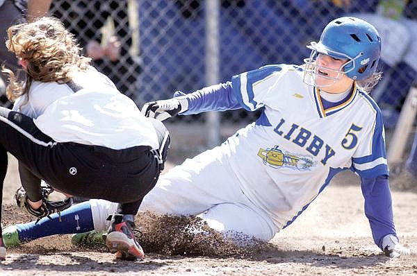 Paul Sievers/The Western News Alysha Martin of Libby slides safely into home following a wild pitch in the bottom of the fifth inning. Martin went 2-for-4 with a double and scored two runs against the Lady Broncs.