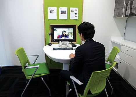 &lt;p&gt;Customer Chung Yong-min does banking through a screen monitor connected to a video conference with bank employee Oh Ji-young, located in another office, at a Smart Banking Center in Seoul, South Korea on Jan. 11. In an age when checks can be deposited by smartphone and almost everyone retrieves cash from ATMs, the corner bank can seem a relic, with its paper deposit slips, marble countertops and human tellers behind glass partitions.&lt;/p&gt;