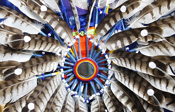 Mission Middle School Seventh grader Issac Carpentier wears a bustle during the K-12 grade Mission powwow on April 9 in the Mission High School gymnasium. A bustle is a traditional feathered decoration worn at Native American ceremonies.