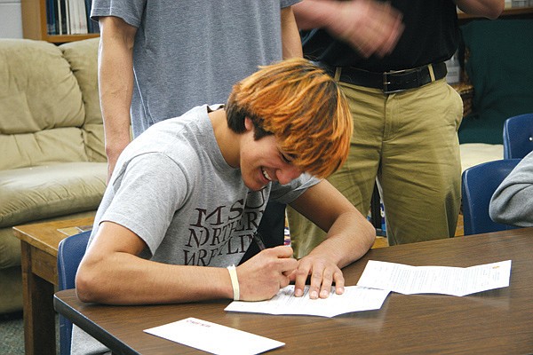 Cameron Neiss signs his letter of intent on Tuesday.