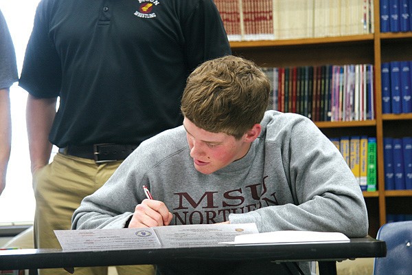 Ronan senior Micky Cheff signs his letter of intent.