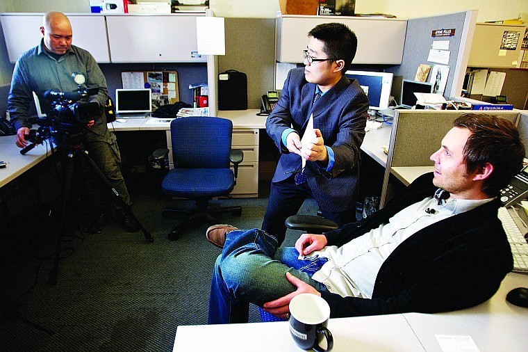 David Cole, a Coeur d'Alene Press reporter, waits for Tak Nomura, center, and Michihiro Hanamura to prepare their video camera for an interview Thursday for a Japanese television show. Cole was interviewed for a story he wrote in 2007 while at the Lewiston Tribune about a man who stole a wallet. Coincidentally, the man's image captured from a video surveillance camera matched a photo taken the same day during an unrelated event.