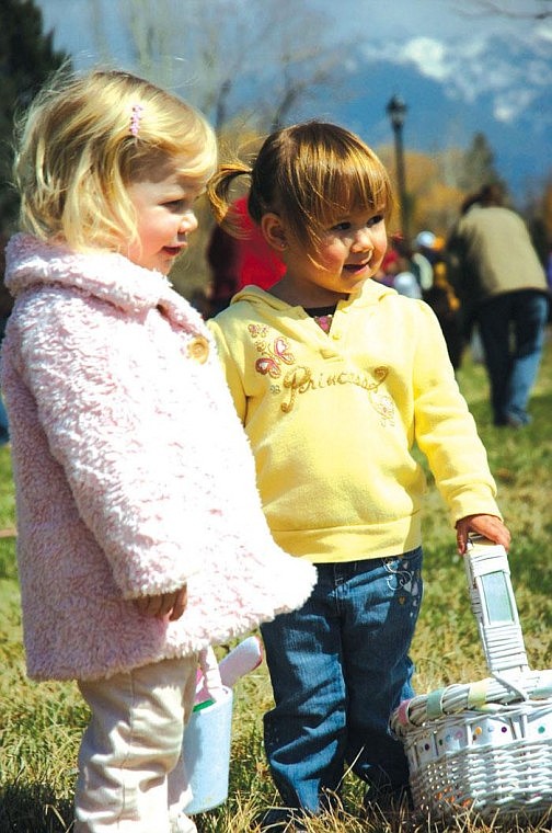 Nashay Johnson, 2, and Hannah Lytton, 2, look for easter eggs together at the Mission Mountain Enterprises, Inc. sponsored 15th Annual Ronan Community Easter Egg Hunt on Saturday.