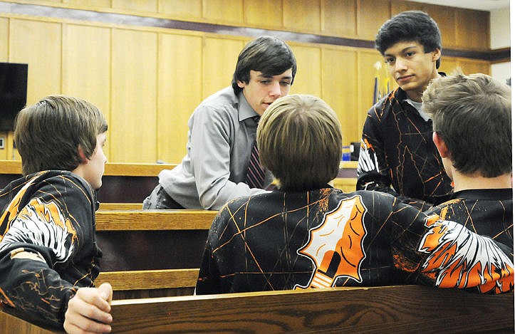 &lt;p&gt;&lt;strong&gt;Payton Hume&lt;/strong&gt;, center, talks with his teammates during a recess at his court hearing Tuesday to see if he could wrestle at the state tournament. (Aaric Bryan/Daily Inter Lake)&lt;/p&gt;