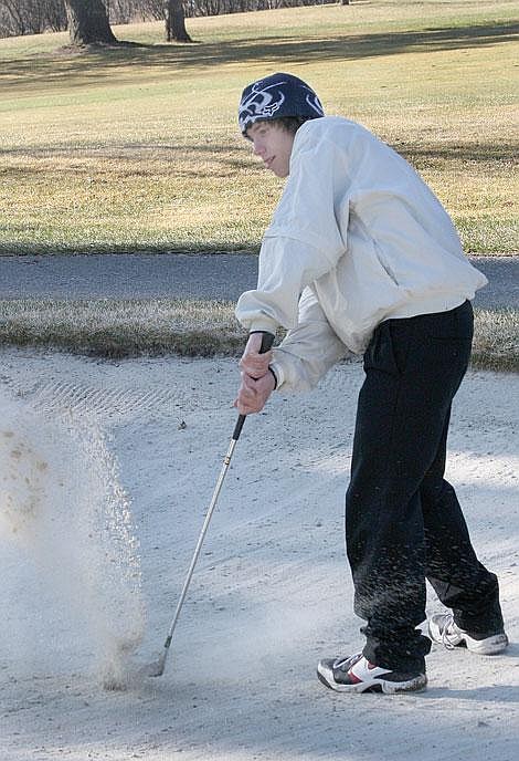 Photo by Nick Ianniello St. Regis Junior Willy Roper tries to get his ball out of the bunker at the Missoula County Country Club during the Loyola Sacred Heart Invitational Golf Tournament Saturday. Roper scored a triple bogey on this hole.