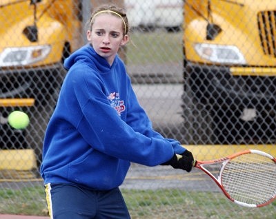 Cari Chamberlain eyes the tennis ball as she readies her racket to send it back to her opponet's side of the court.