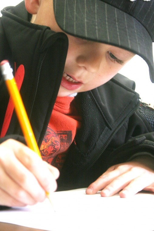 Five-year-old Hayden Conn takes a developmental test during the kindergarten round up on Friday. The day is an opportunity for school teachers to determine the children's ability to transfer seamlessly into the classroom.