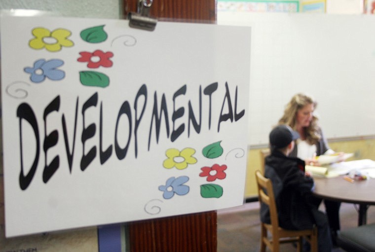 Teachers work with students during a preliminary screening that tests the development of pre-schoolers.