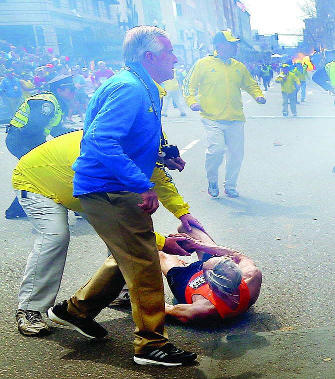 <p>People react to a second explosion near the Boston Marathon finish line Monday.</p>