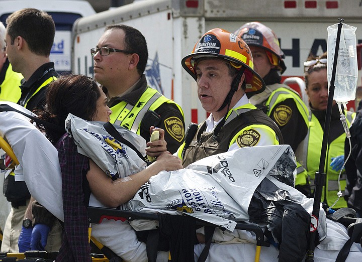 &lt;p&gt;Emergency responders comfort a woman on a stretcher who was injured in a bomb blast near the finish line of the Boston Marathon Monday, April 15, 2013 in Boston. Two bombs exploded in the packed streets near the finish line of the marathon on Monday, killing at least two people and injuring more than 80, authorities said. (AP Photo/Jeremy Pavia)&lt;/p&gt;