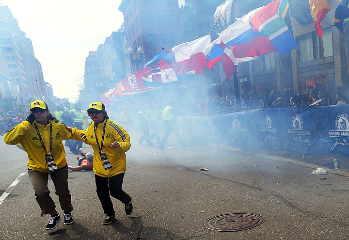 &lt;p&gt;People react to an explosion at the 2013 Boston Marathon in Boston, Monday, April 15, 2013. Two explosions shattered the euphoria of the Boston Marathon finish line on Monday, sending authorities out on the course to carry off the injured while the stragglers were rerouted away from the smoking site of the blasts. (AP Photo/The Boston Globe, John Tlumacki) MANDATORY CREDIT&lt;/p&gt;