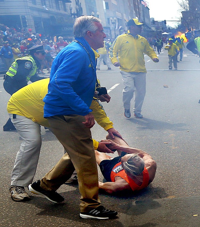 &lt;p&gt;People react to a second explosion at the 2013 Boston Marathon in Boston, Monday, April 15, 2013. Two explosions shattered the euphoria of the Boston Marathon finish line on Monday, sending authorities out on the course to carry off the injured while the stragglers were rerouted away from the smoking site of the blasts. (AP Photo/The Boston Globe, John Tlumacki) MANDATORY CREDIT&lt;/p&gt;