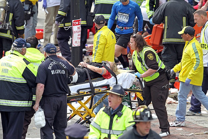 &lt;p&gt;Rescue personnel aid injured people near the finish line of the 2013 Boston Marathon following explosions in Boston, Monday, April 15, 2013. Two explosions shattered the euphoria of the Boston Marathon finish line on Monday, sending authorities out on the course to carry off the injured while the stragglers were rerouted away from the smoking site of the blasts. (AP Photo/The Boston Herald, Stuart Cahill)&lt;/p&gt;