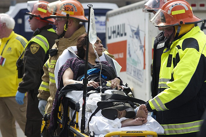 &lt;p&gt;Emergency responders aid a woman on a stretcher who was injured in a bomb blast near the finish line of the Boston Marathon Monday, April 15, 2013 in Boston. Two bombs exploded in the packed streets near the finish line of the marathon on Monday, killing at least two people and injuring more than 80, authorities said. (AP Photo/Jeremy Pavia)&lt;/p&gt;